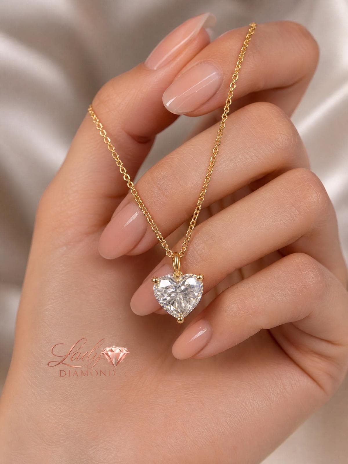 Gold diamond heart necklace in hand